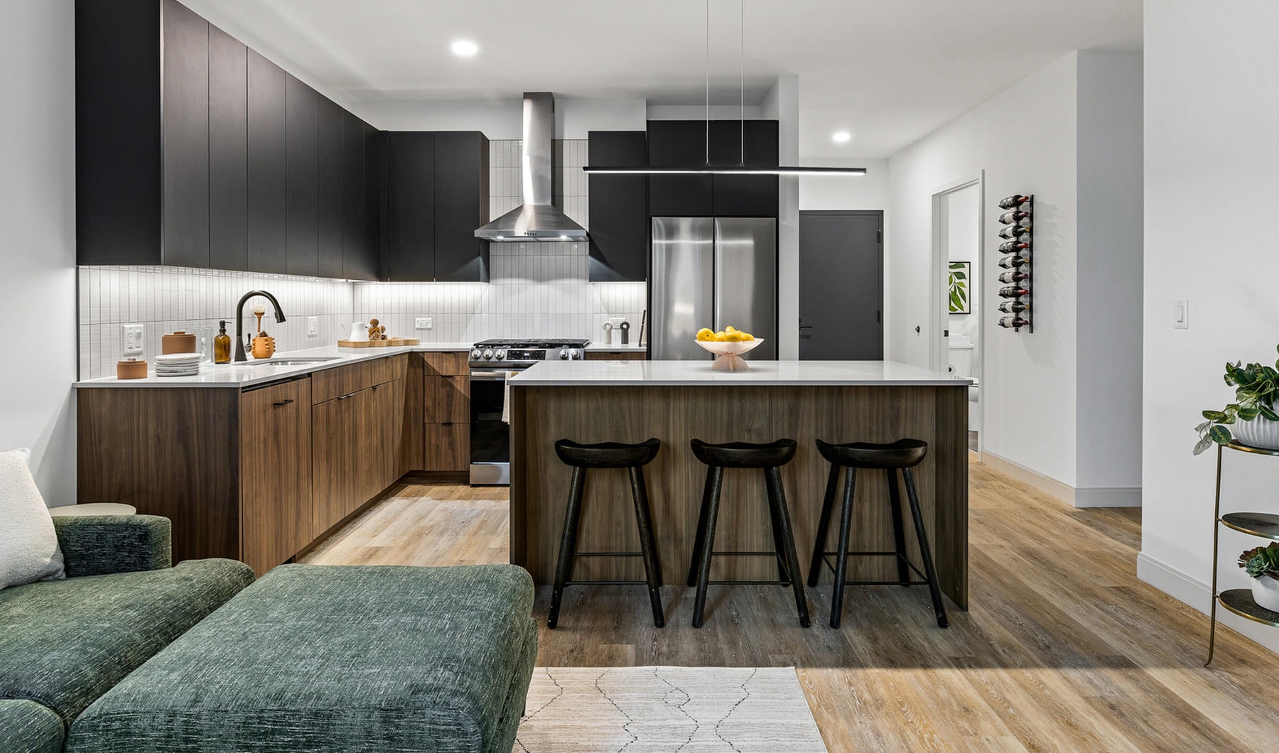 kitchen with black cabinets and stainless steel appliances