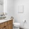 Design forward bathroom with backlit mirror